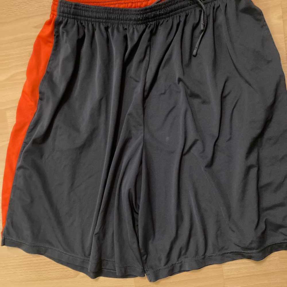 Nike shorts. Black and Orange. Small stain on front in picture.
